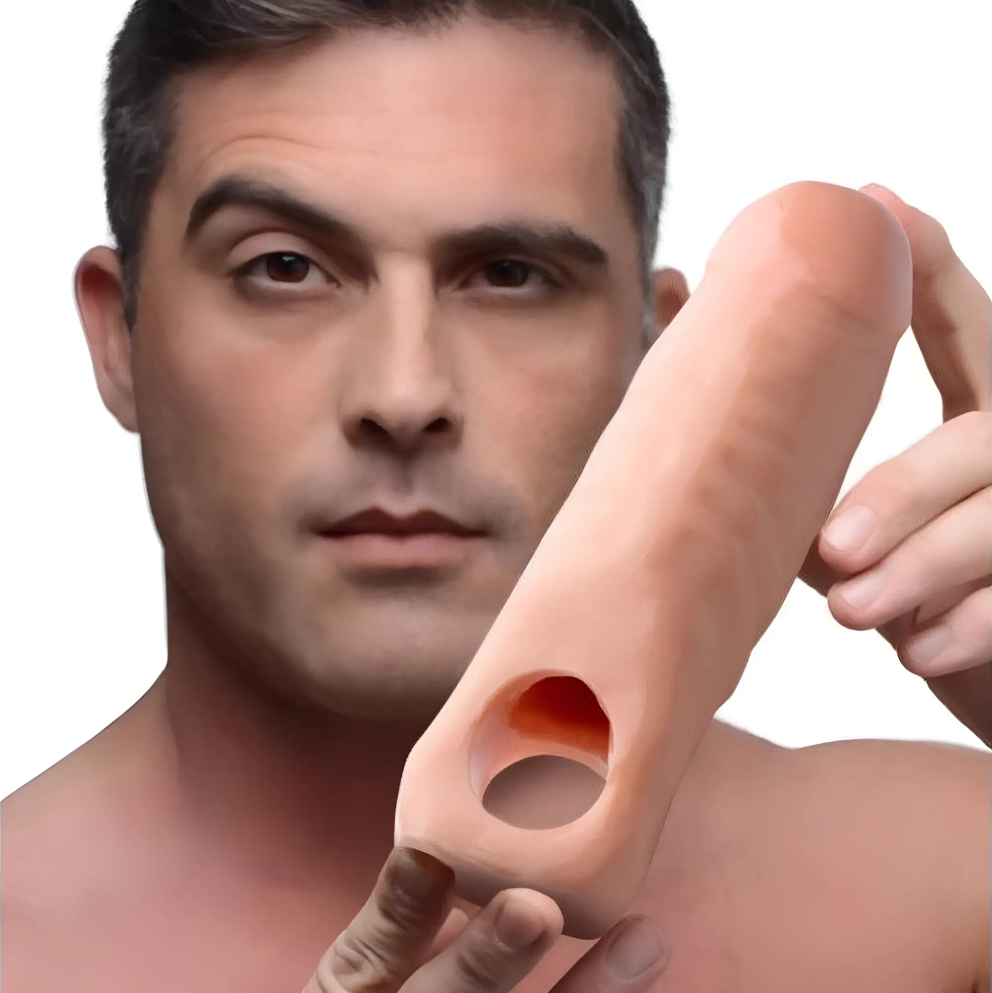 Man holding a 7-inch flesh-toned Size Matters penis extension sleeve with a hollow, cylindrical design.