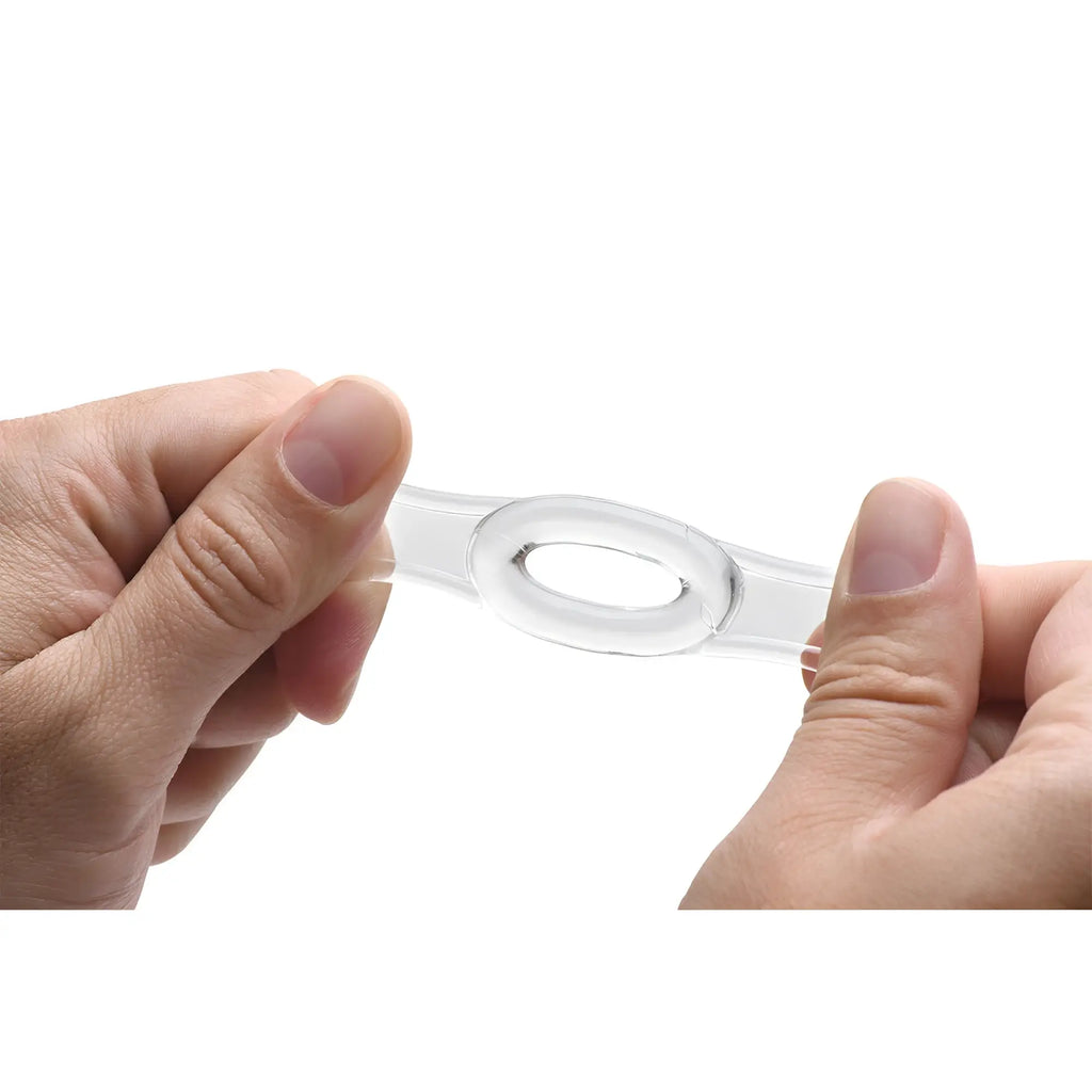 Hands stretching a clear, flexible silicone ring from the Size Matters The Endurance Penis Ring Set.