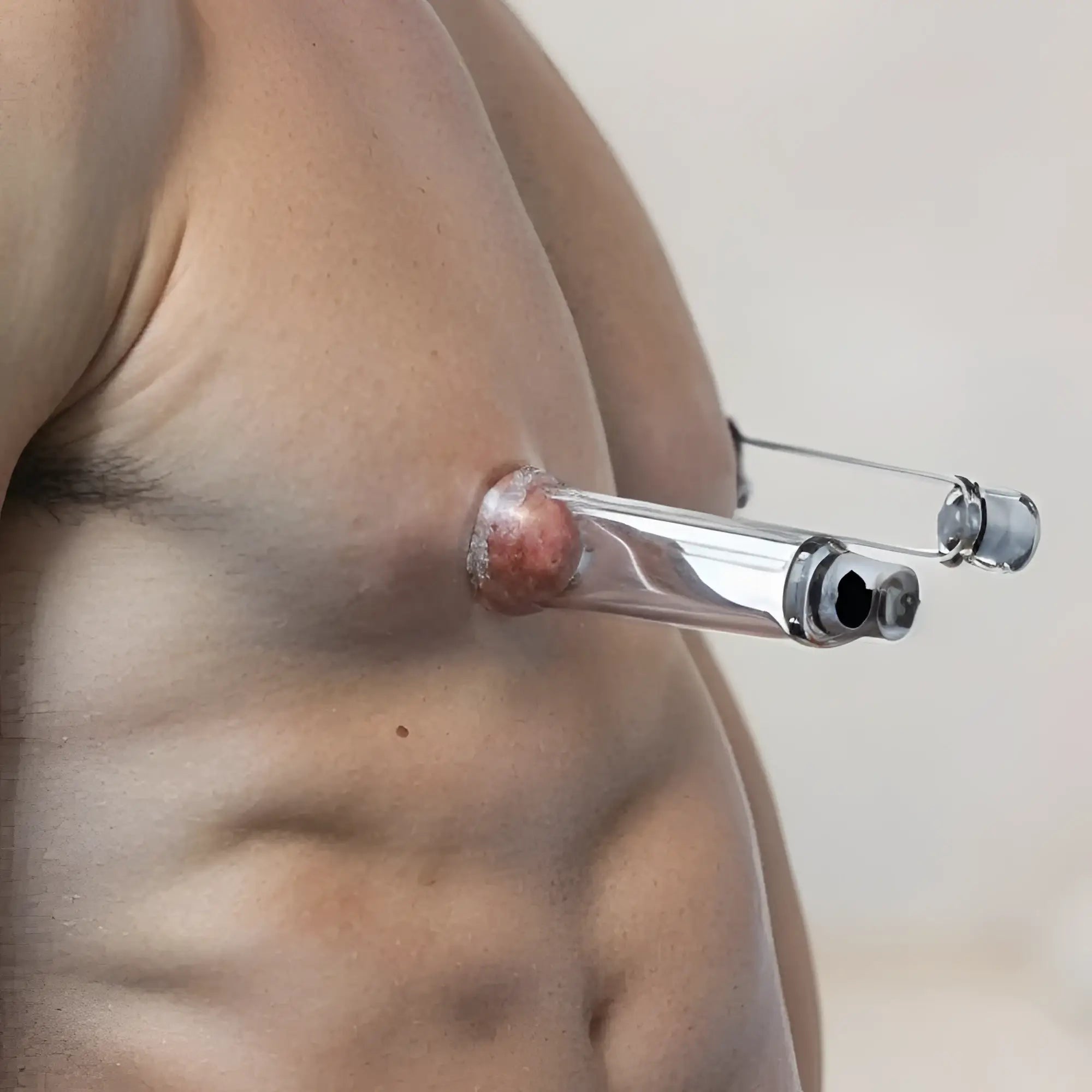Size Matters Nipple Cylinders: clear, tube-shaped suction devices attached to a person's chest.