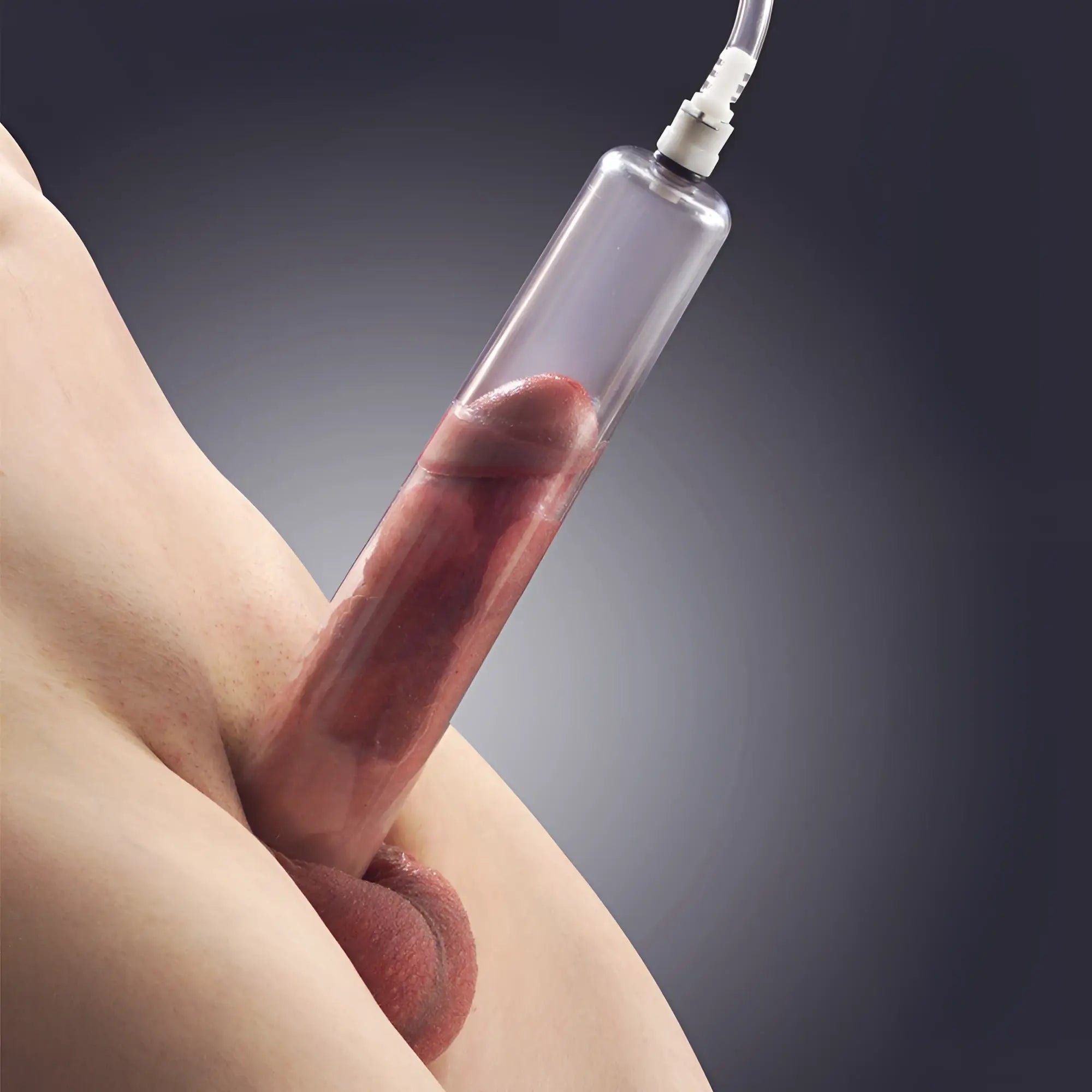 Size Matters Penis Pump Cylinder, a clear plastic vacuum tube attached to a hose, shown in use on male genitalia.