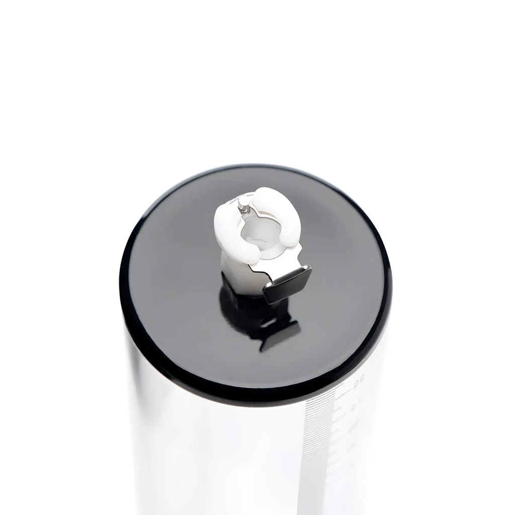 Size Matters 2-inch clear cylinder pump with a black cap and white valve mechanism viewed from the top.