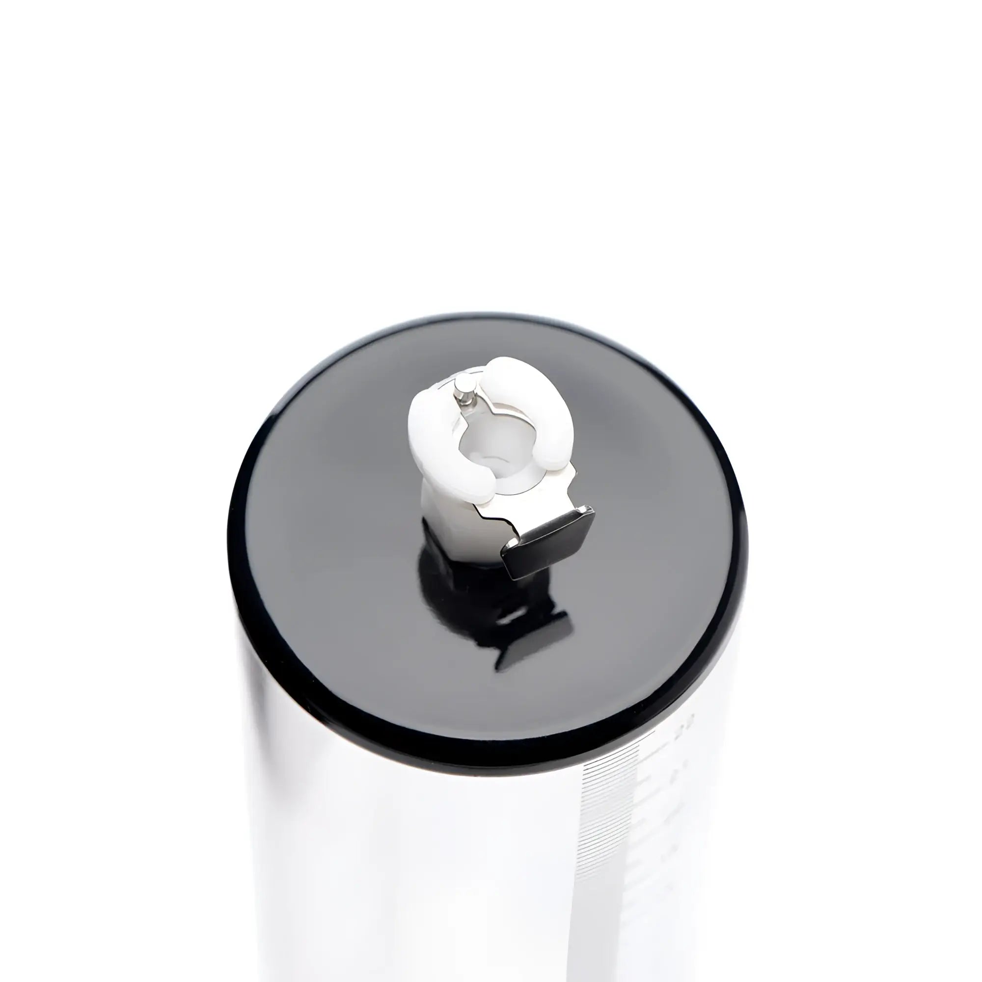Size Matters 2-inch clear cylinder pump with a black cap and white valve mechanism viewed from the top.