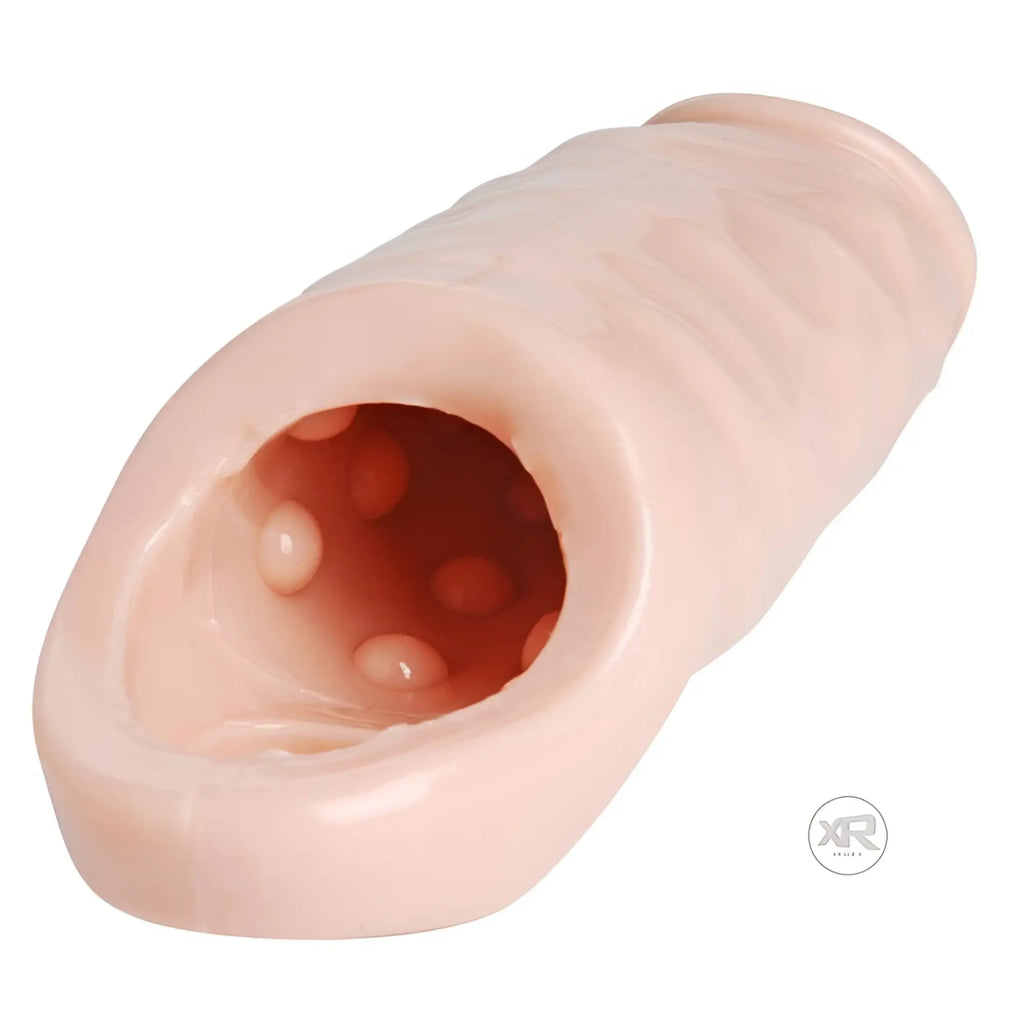 Size Matters Really Ample XL enhancer: light peach textured silicone sleeve with a hollow, dimpled interior.