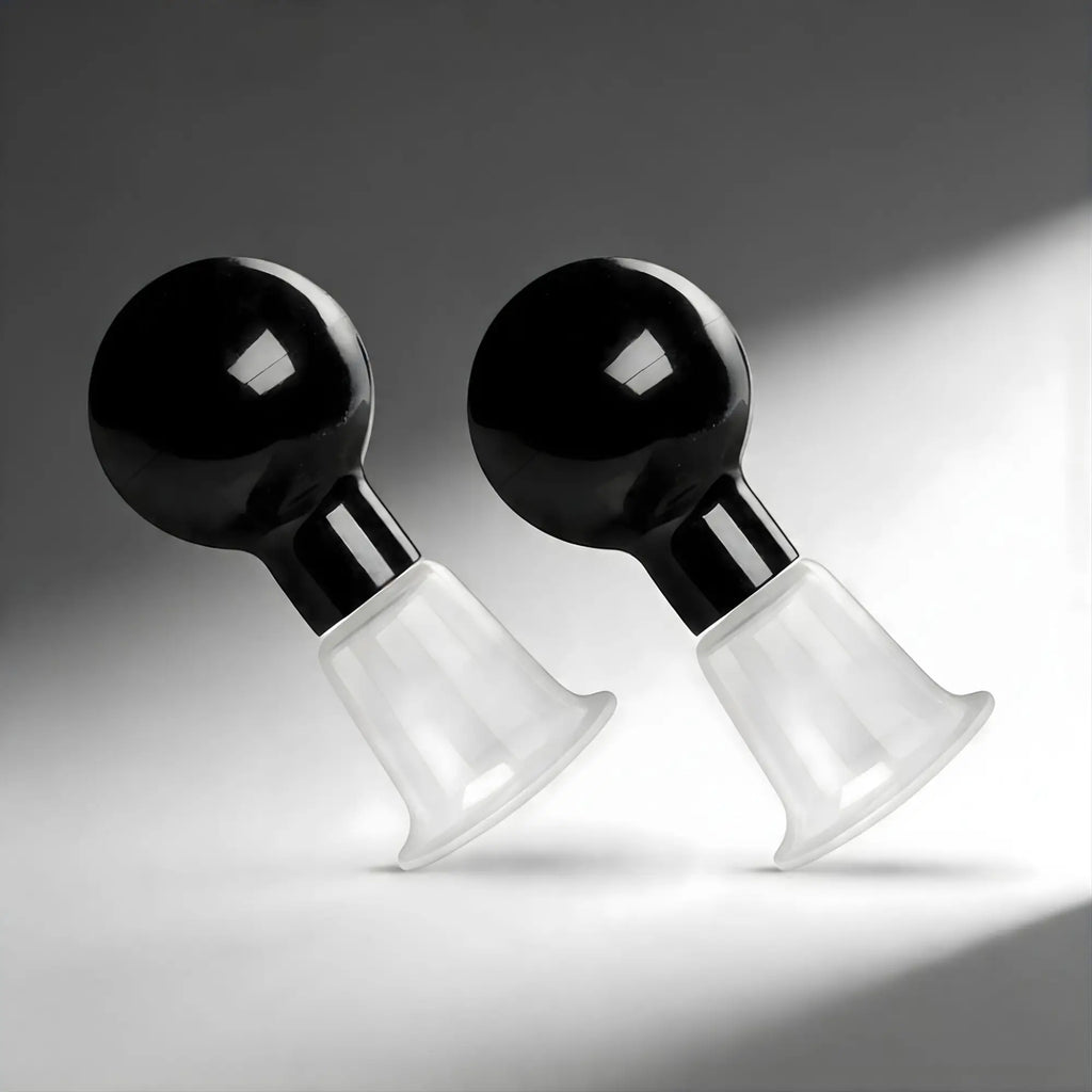 Size Matters See Thru Nipple Boosters: A pair of devices with black bulb pumps and clear, flared suction cups.