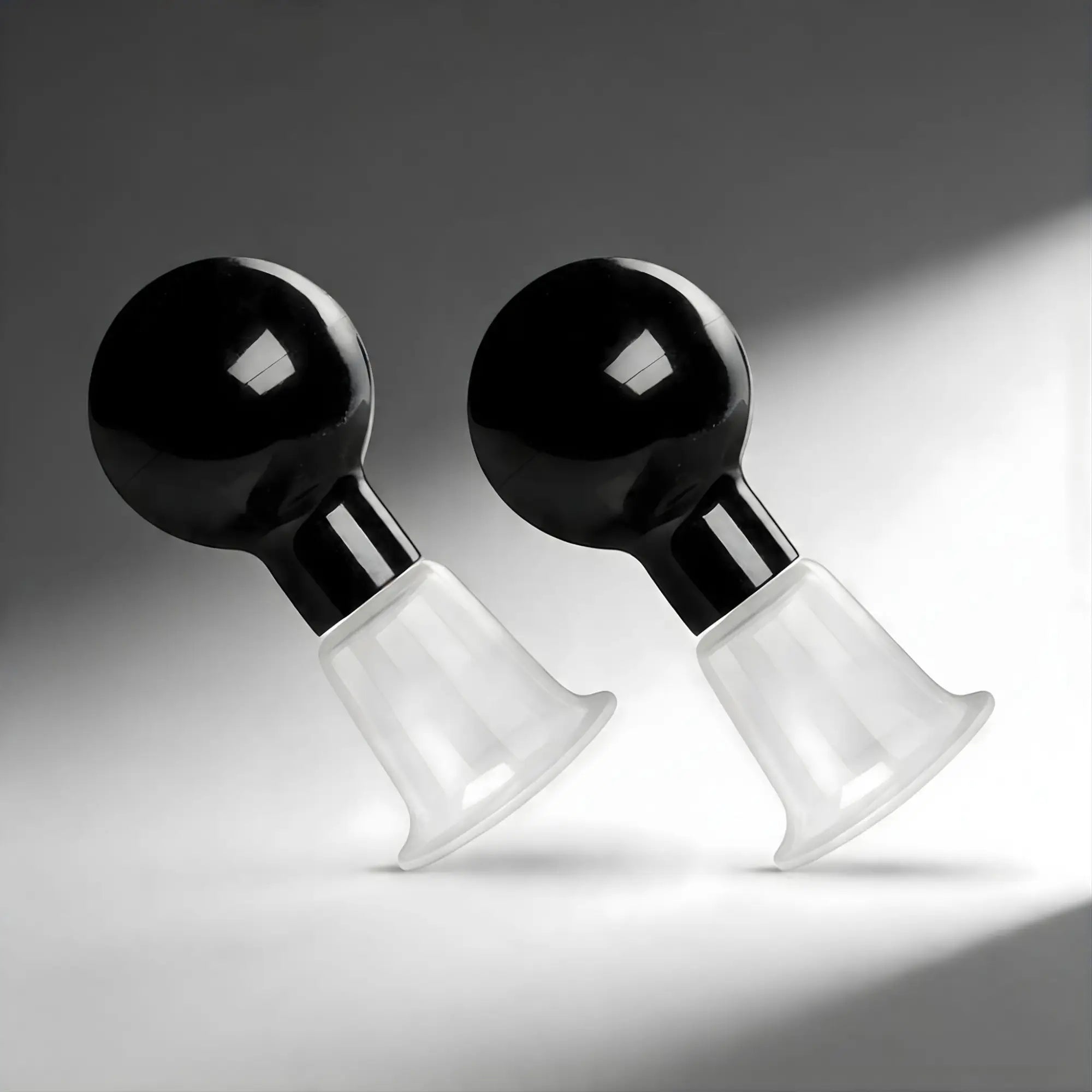 Size Matters See Thru Nipple Boosters: A pair of devices with black bulb pumps and clear, flared suction cups.