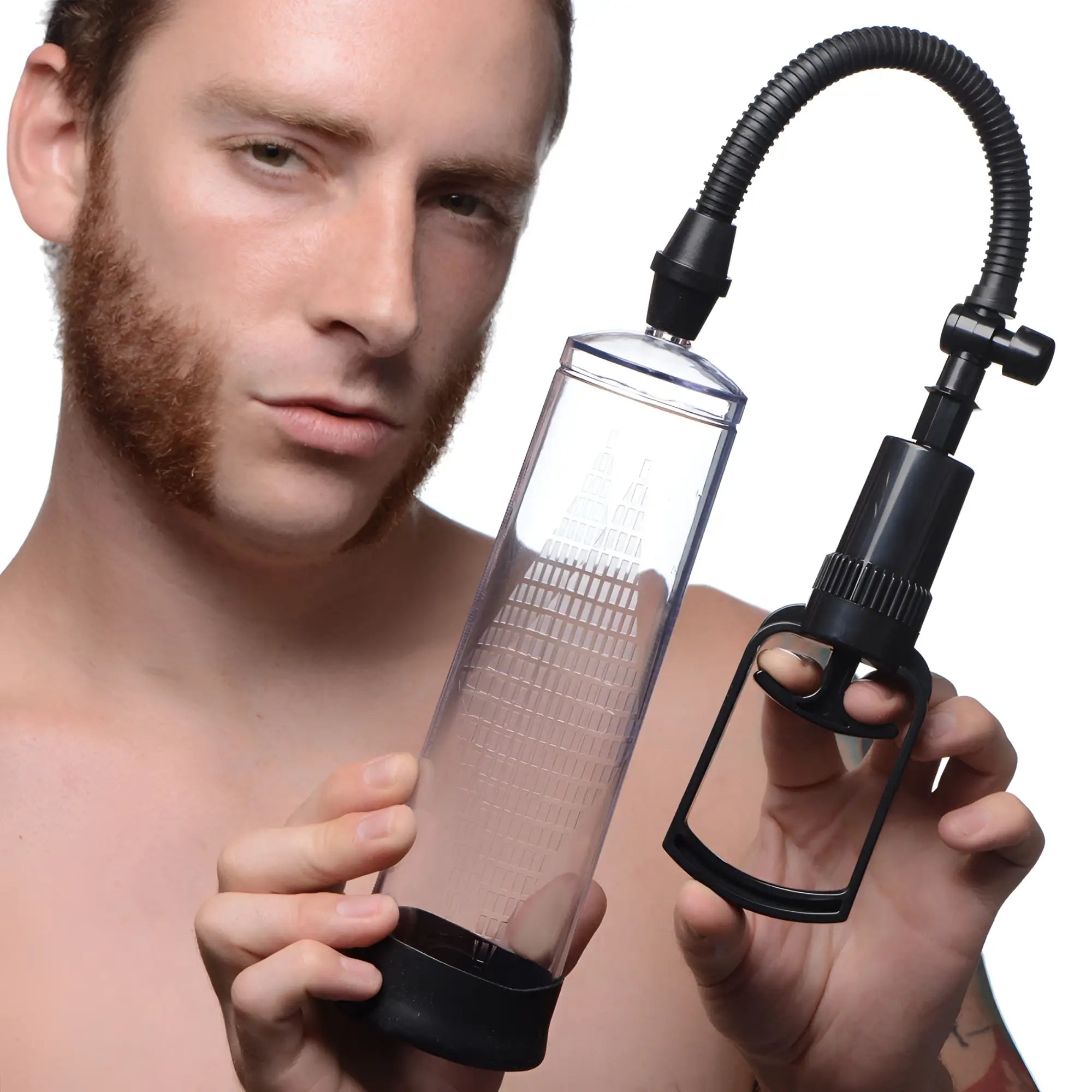 A man holds a Size Matters Trigger penis pump with a clear cylinder and black hand-trigger vacuum pump.