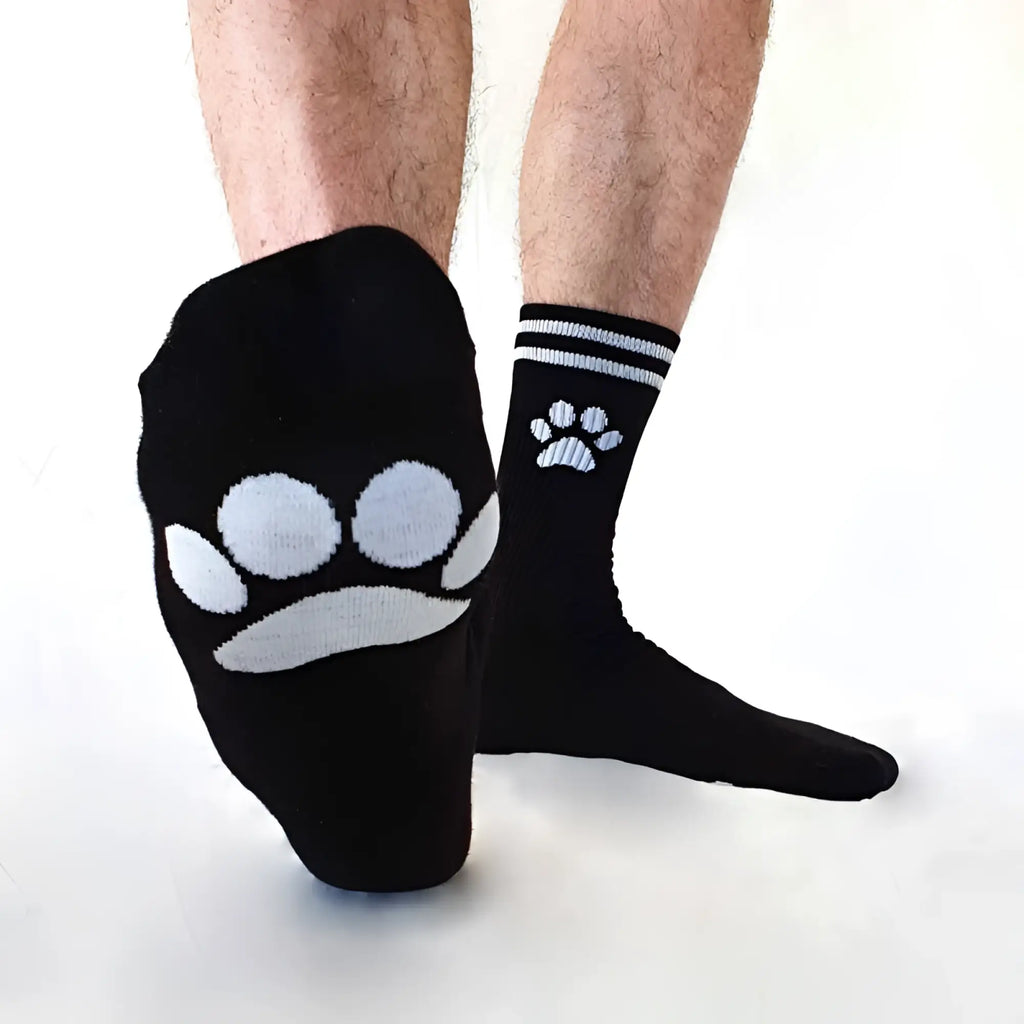 Black Sk8erboy puppy socks with white paw prints, larger on foot and smaller near ankle, size 39-42