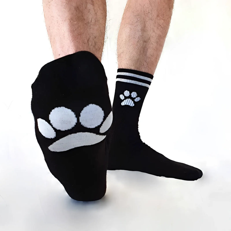 Black Sk8erboy puppy socks with white paw prints, larger on foot and smaller near ankle, size 39-42