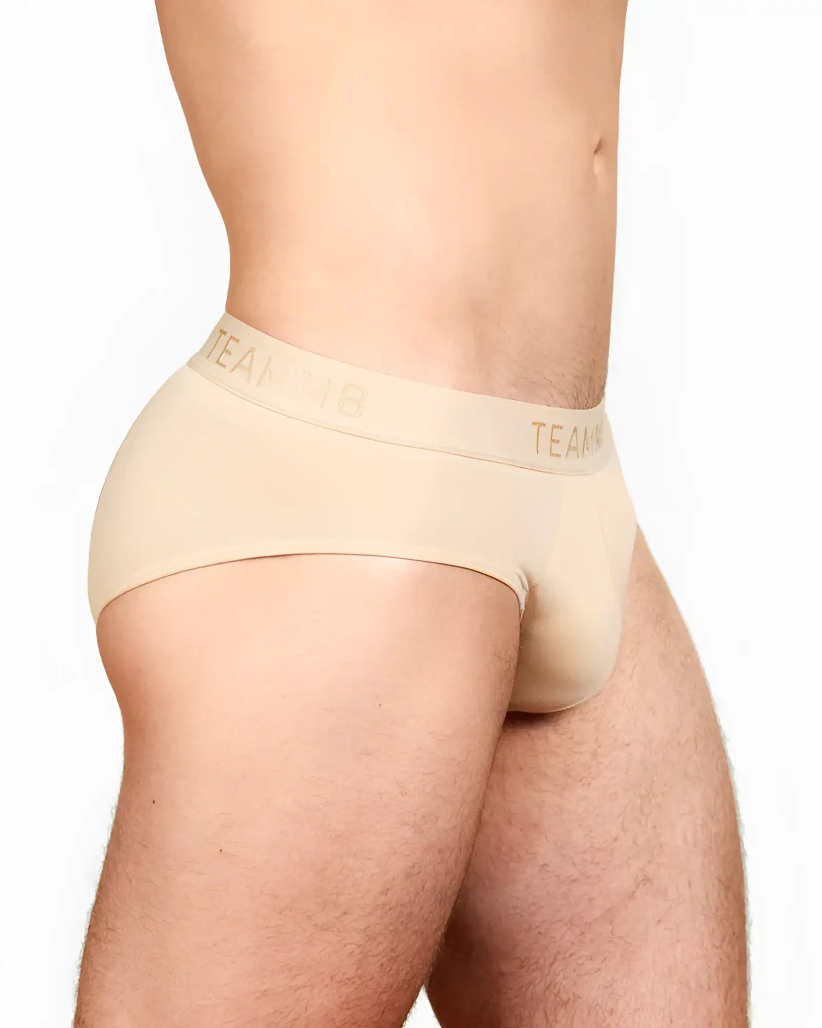 Beige skin brief with matching elastic waistband featuring team logo in gold lettering for men’s underwear