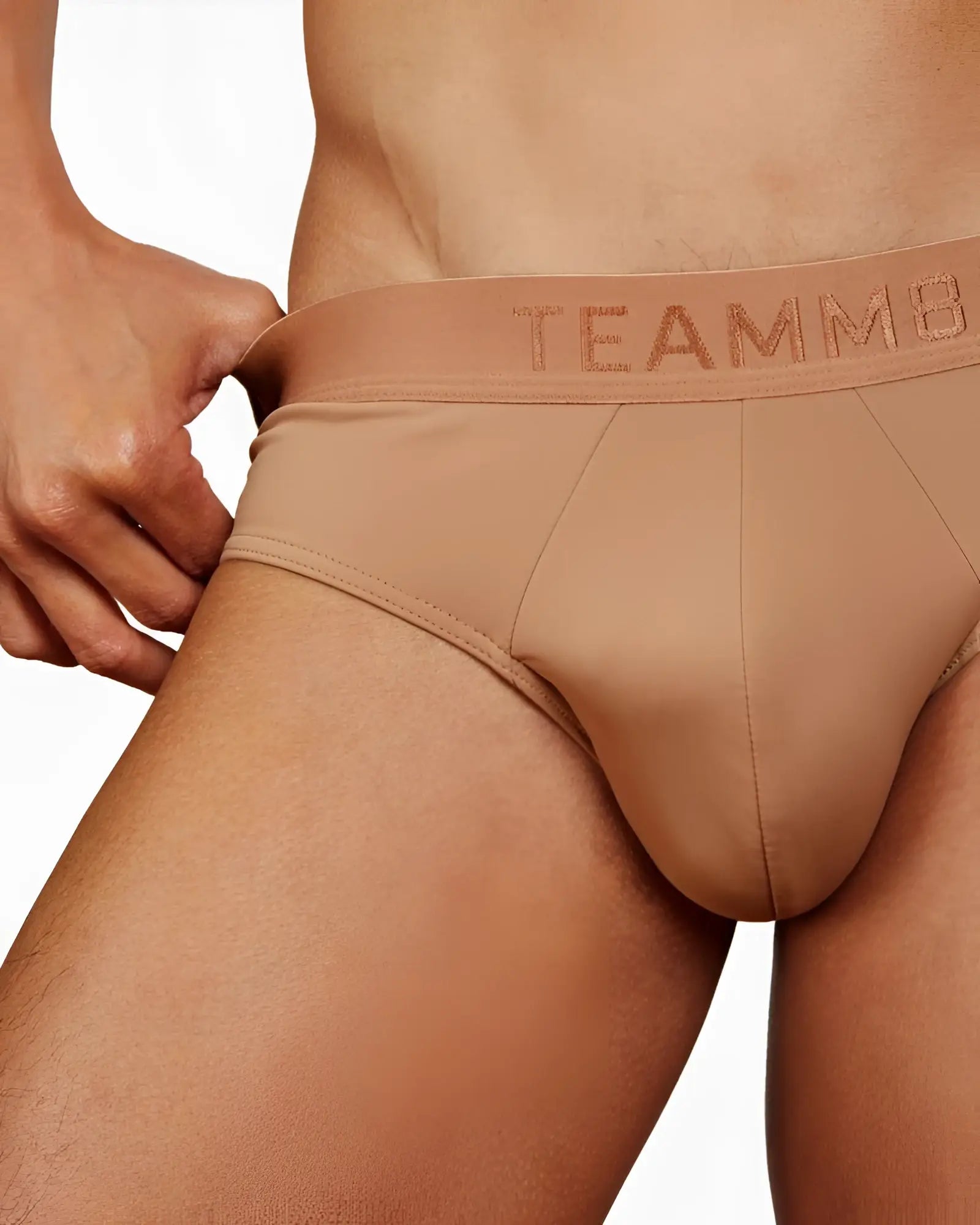 Tan-colored team8 men’s skin brief gorgeous with smooth form-fitting fabric and subtle stitching details