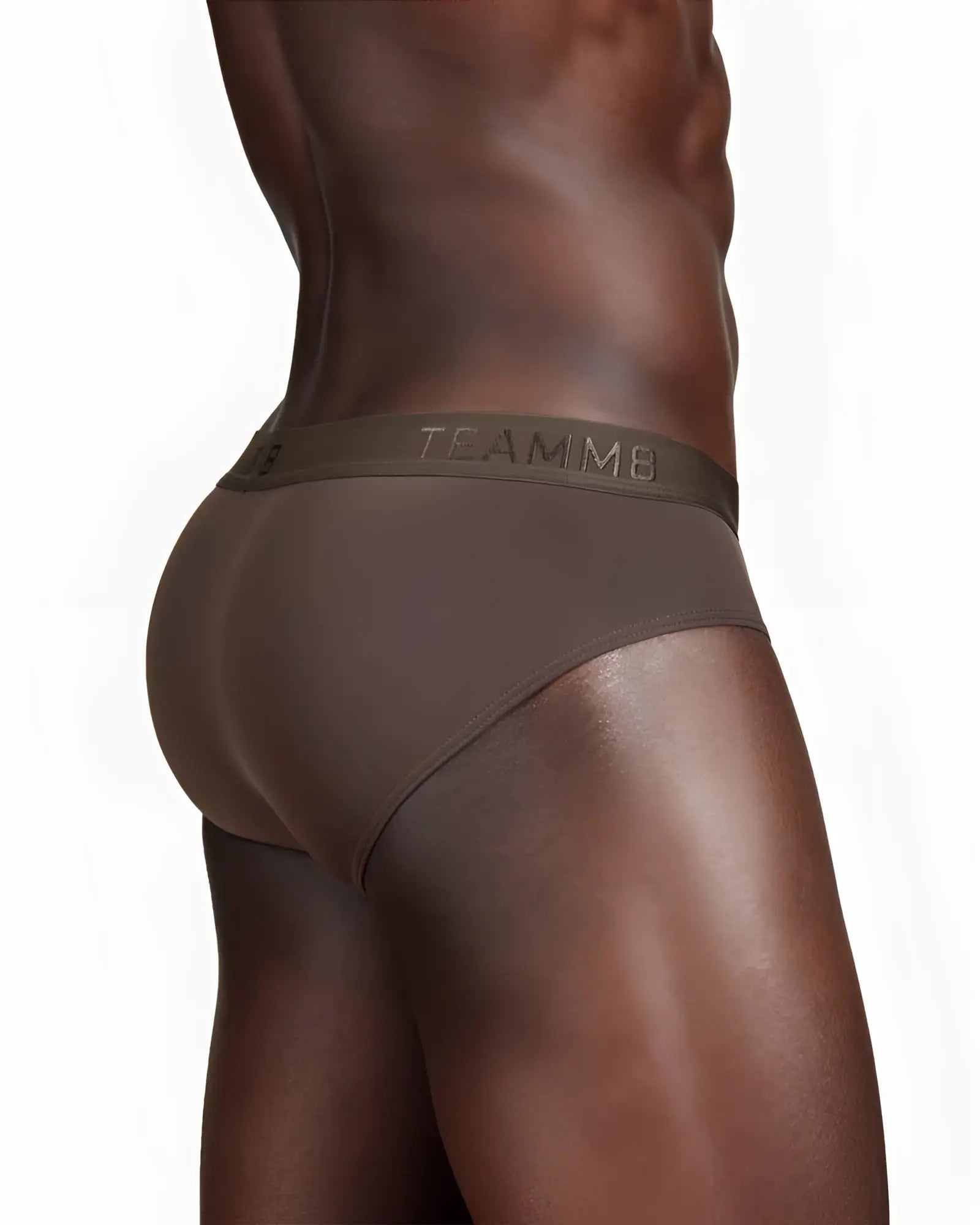 Brown skin brief with smooth form-fitting fabric and subtle branding along the waistband showing the back side