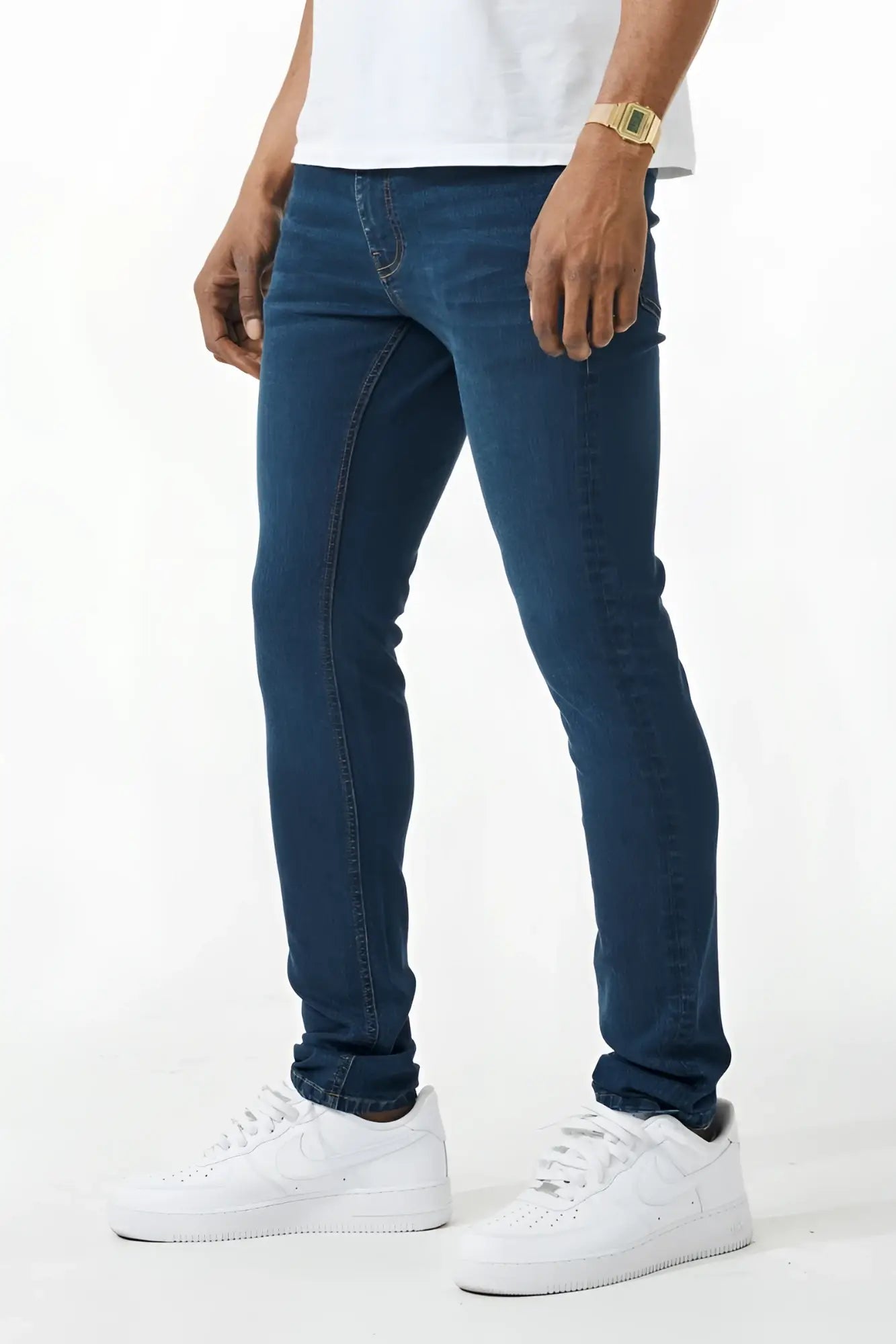 Dark blue skinny fit denim jeans with slim fit, five-pocket design, and subtle fading along the thighs