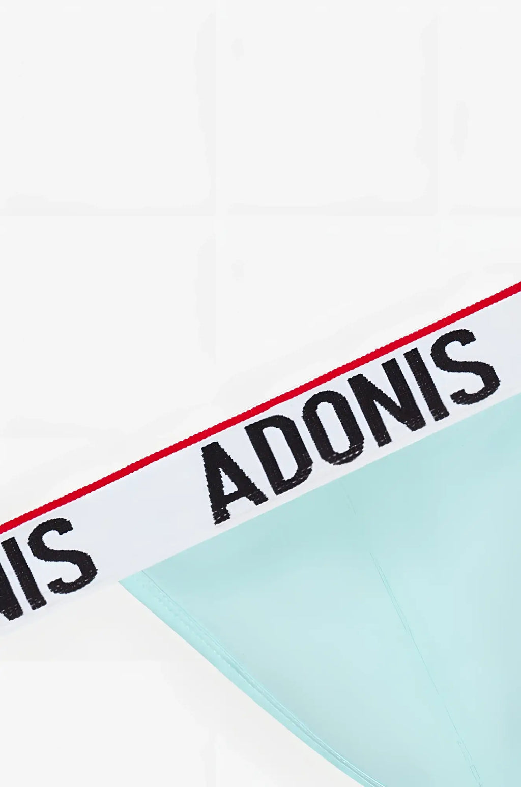 Mint green sky blue thong with white waistband featuring bold black adonis lettering and red trim visible on front side