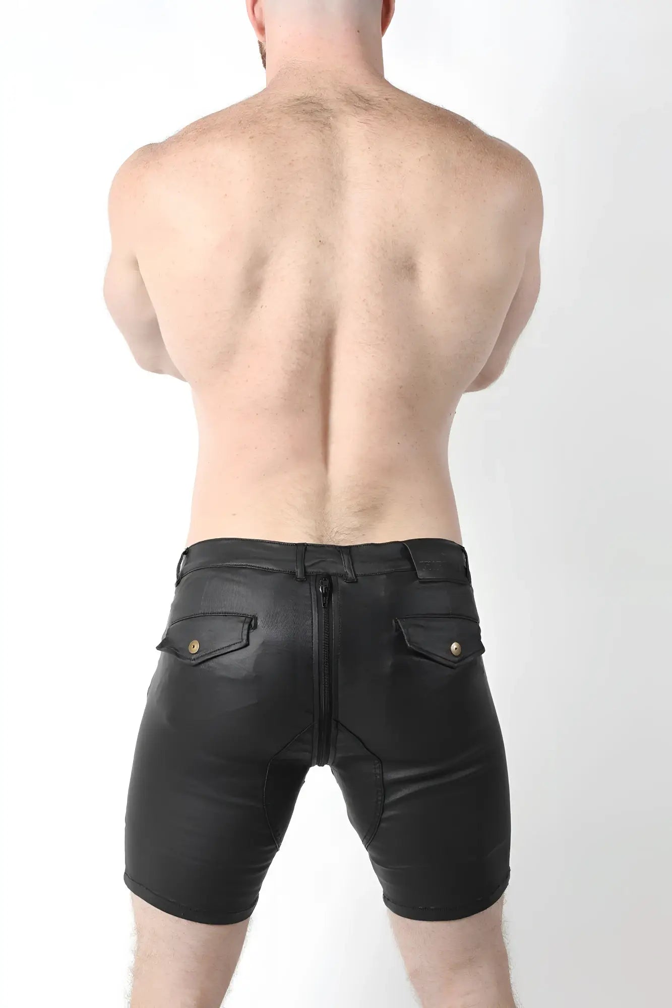 Back view of slick carpenter zipper short v2 in black leather with gold-tone button accents on back pockets