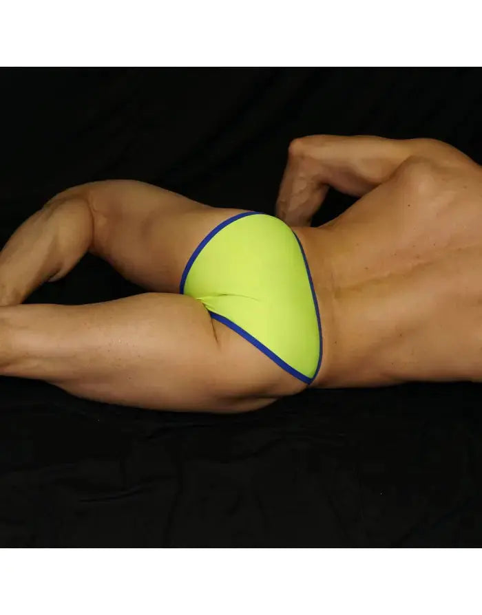 Neon blue bikini underwear by Arroyman featuring a snug fit and contrasting trim shown on a model lying down.