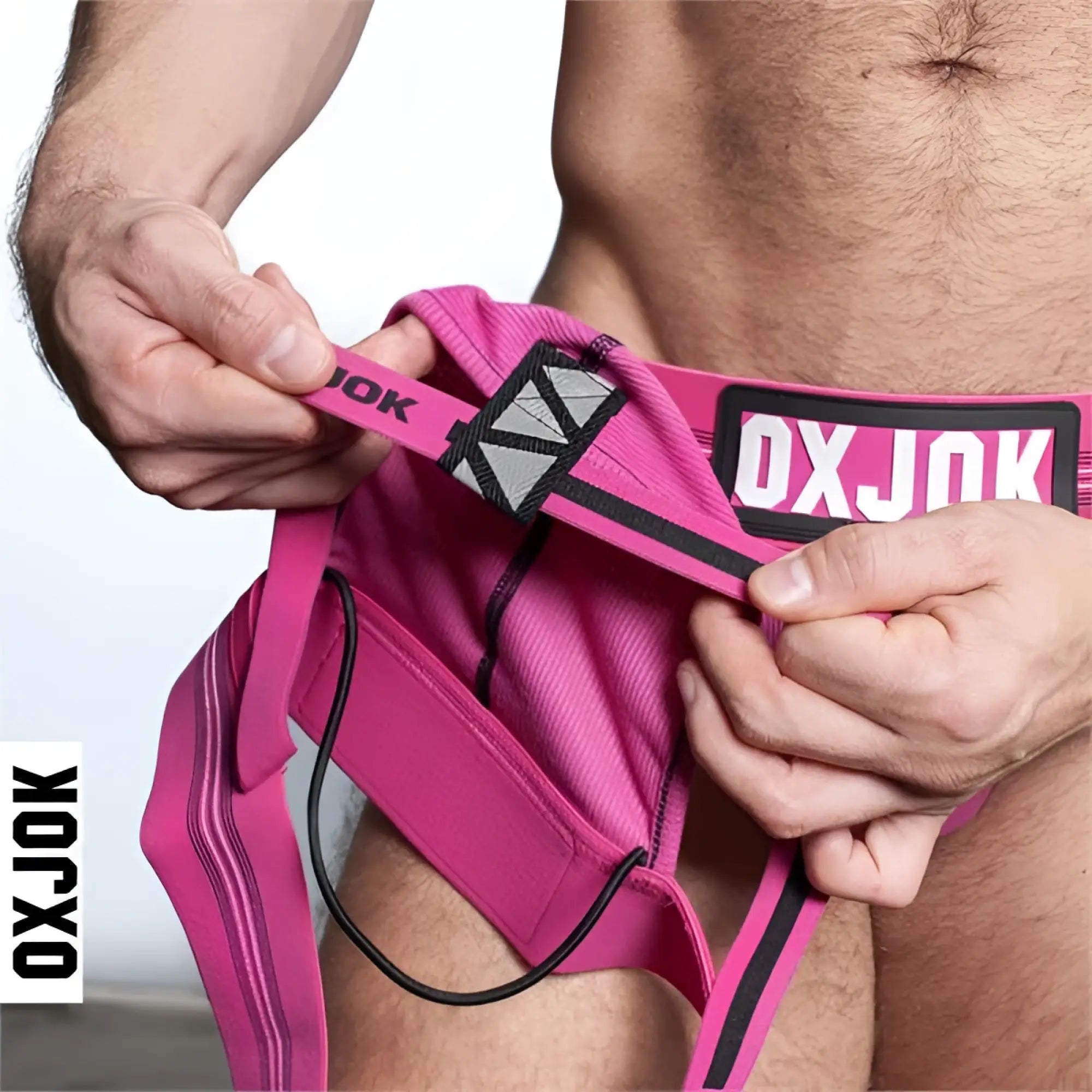 Bright pink oxjok slingjock jockstrap briefs with black trim and geometric pattern waistband front view
