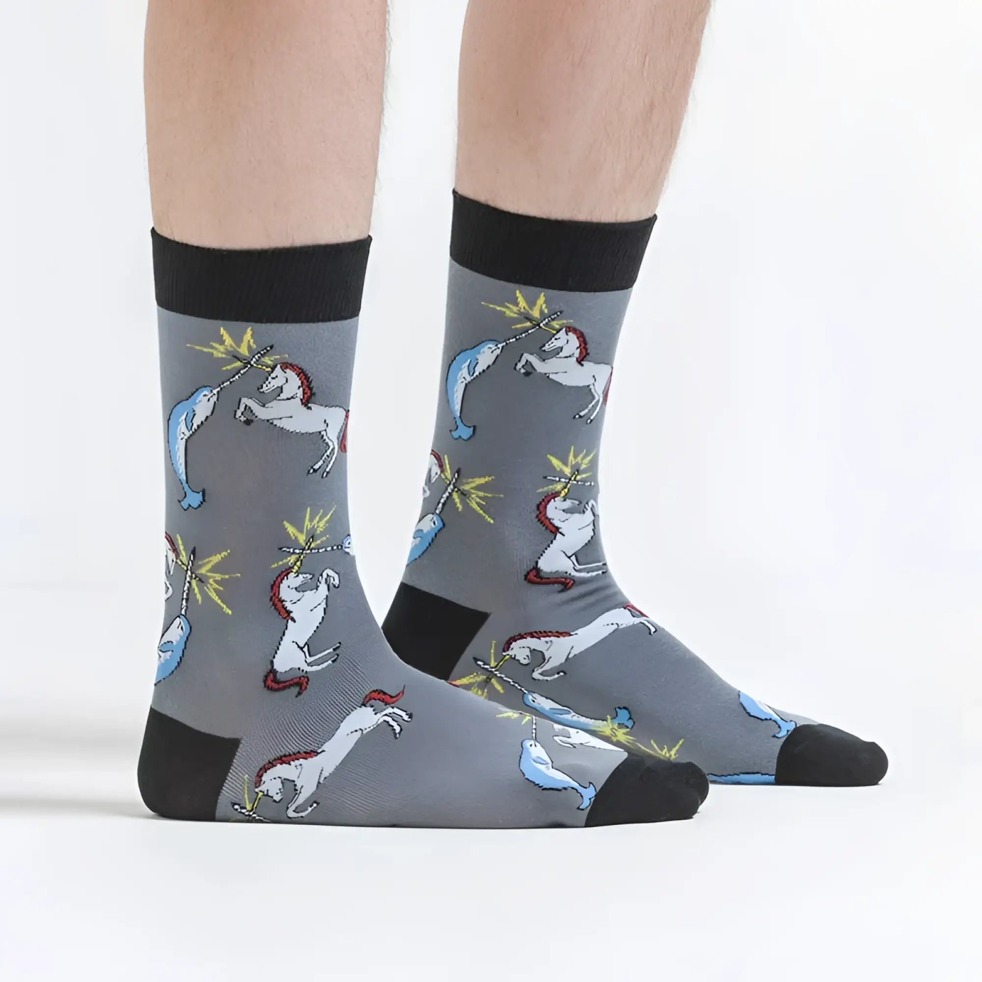 Gray socks with black cuffs and toe caps featuring playful white unicorn and blue narwhal battle pattern sock it to me size s