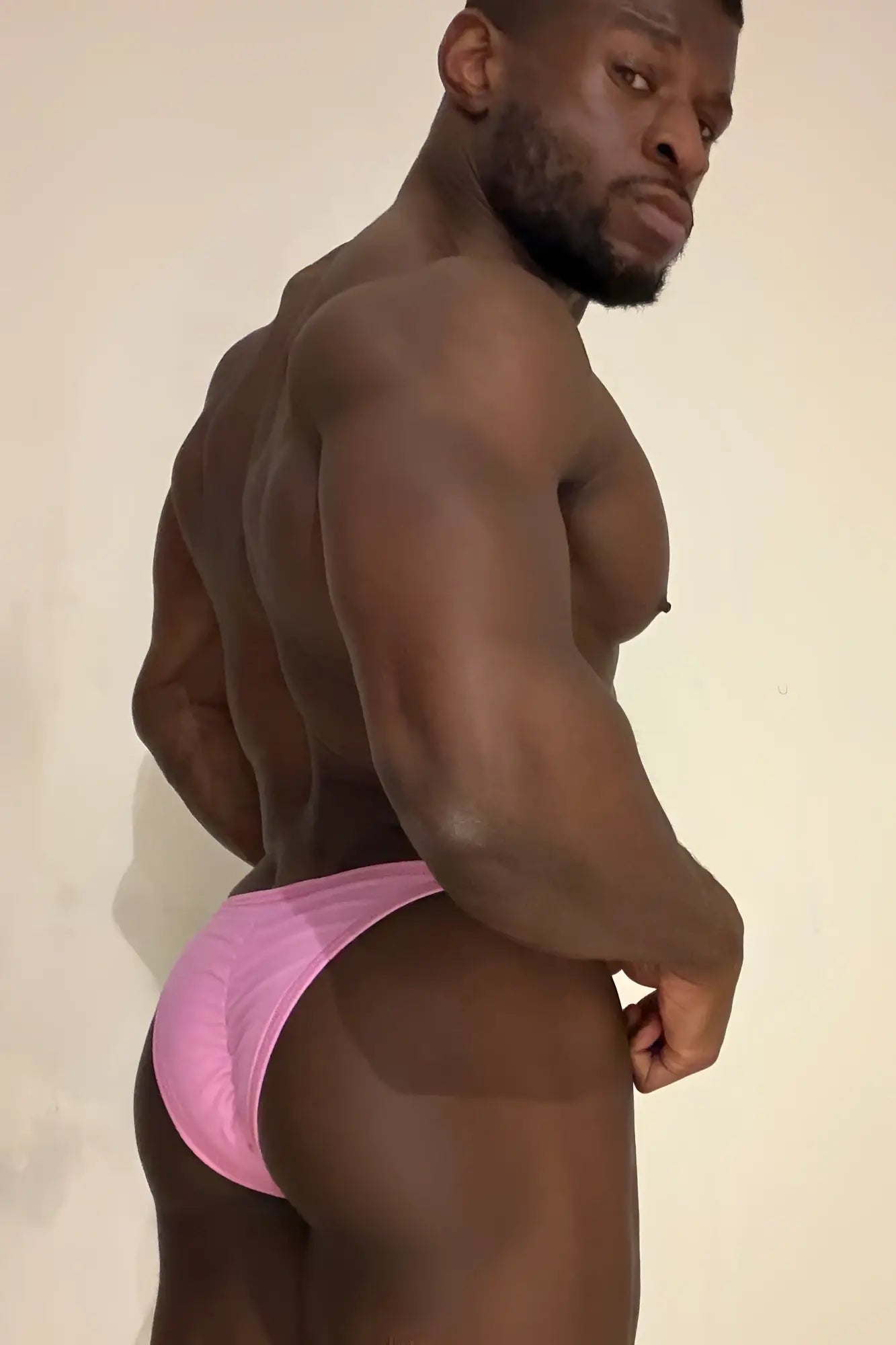 Pink soft vegan leather scrunch-butt briefs showing the back side with a flattering scrunched design