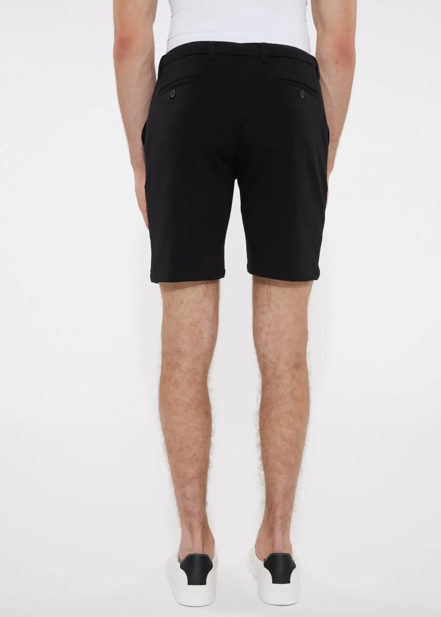 Black solid stretch knit shorts with a sleek modern cut and subtle side pockets for versatile wear