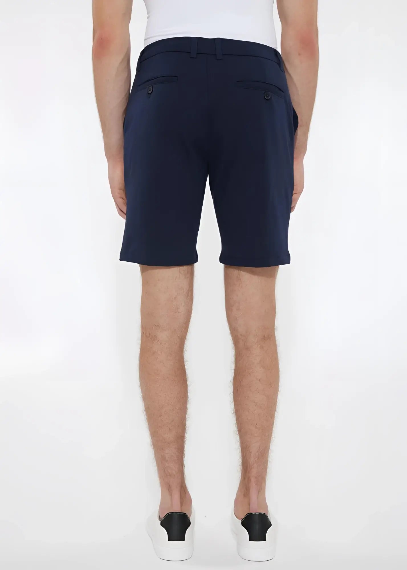 Navy blue solid stretch knit shorts with buttoned back pockets shown from the back in a tailored modern cut