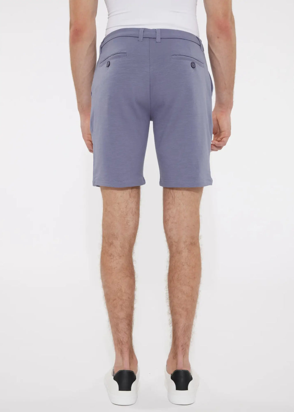 A pair of men’s solid stretch knit shorts in soft lavender with lightweight fabric and dark button accents on the back side
