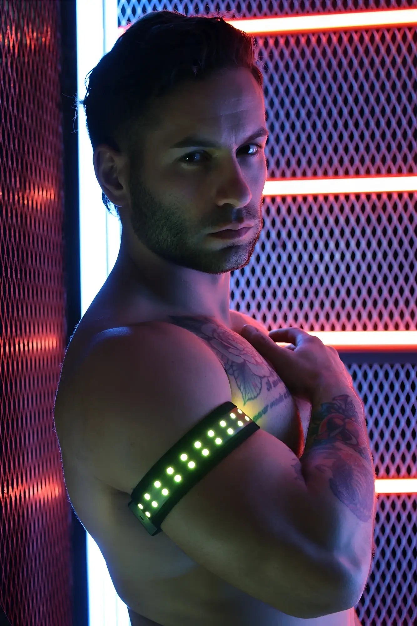 A sleek black led soundwave armband with glowing green lights designed for wearable audio control
