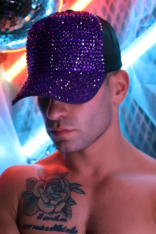 A purple spark trucker hat with dazzling crystal-encrusted design, black brim, and adjustable strap