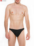 Black sleek form fitting splash c ring thong swim trunks with minimalist design shown from the back side