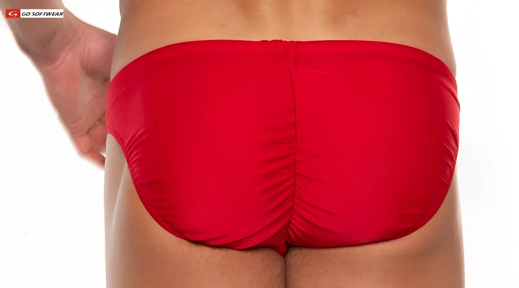 Bright red shiny fabric sport buns bikini swim trunks showing ruched back design