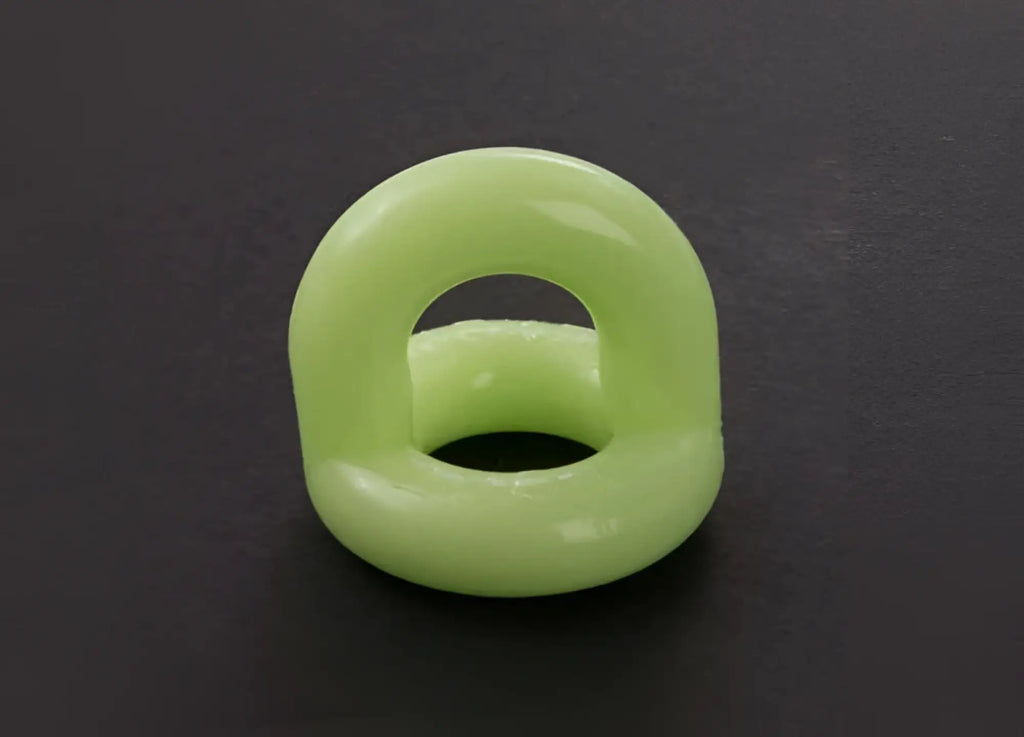 A smooth light green sport f-cker tpr c ring made of silicone with a glossy finish and an open center size one size