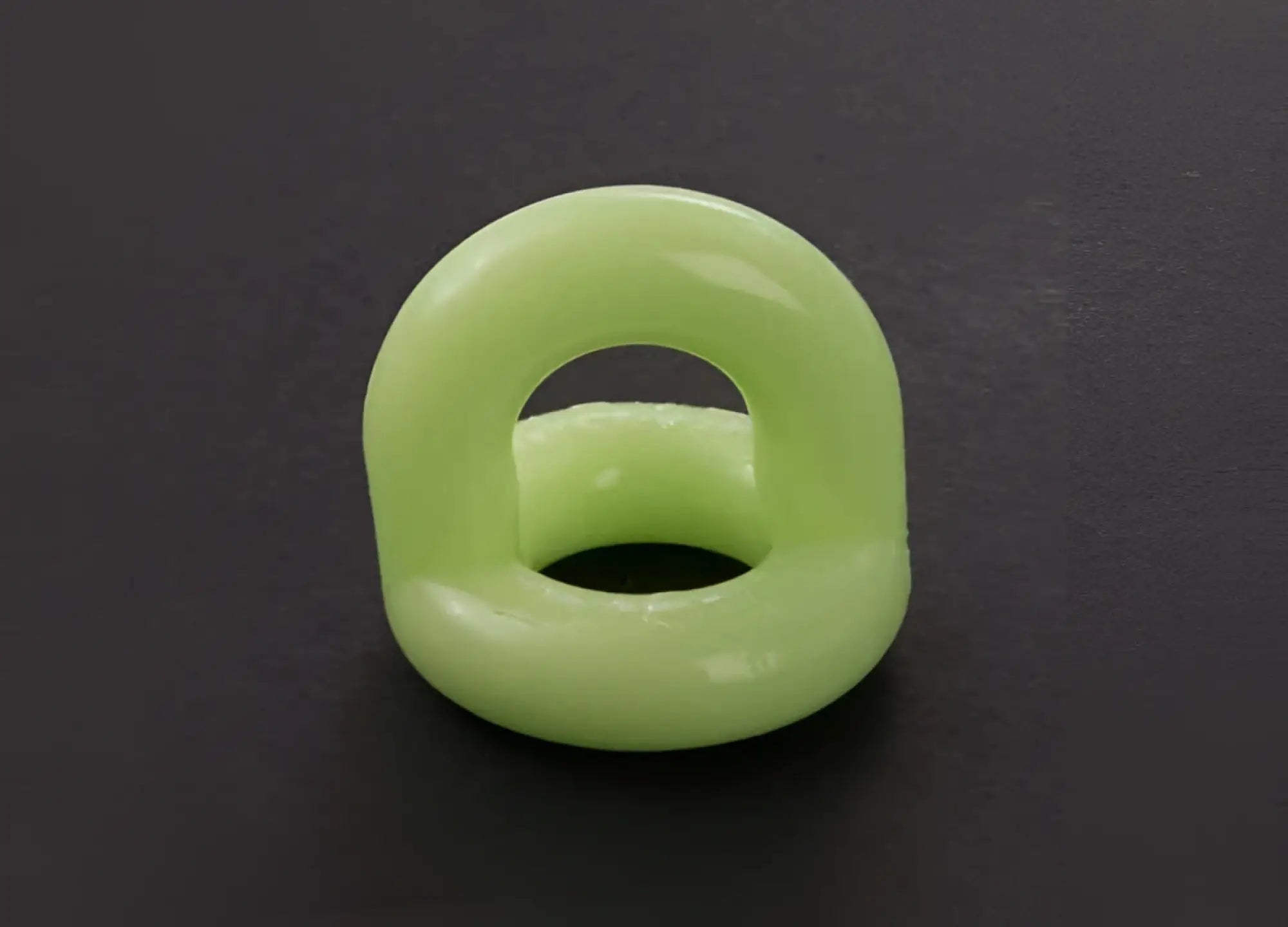 A smooth light green sport f-cker tpr c ring made of silicone with a glossy finish and an open center size one size