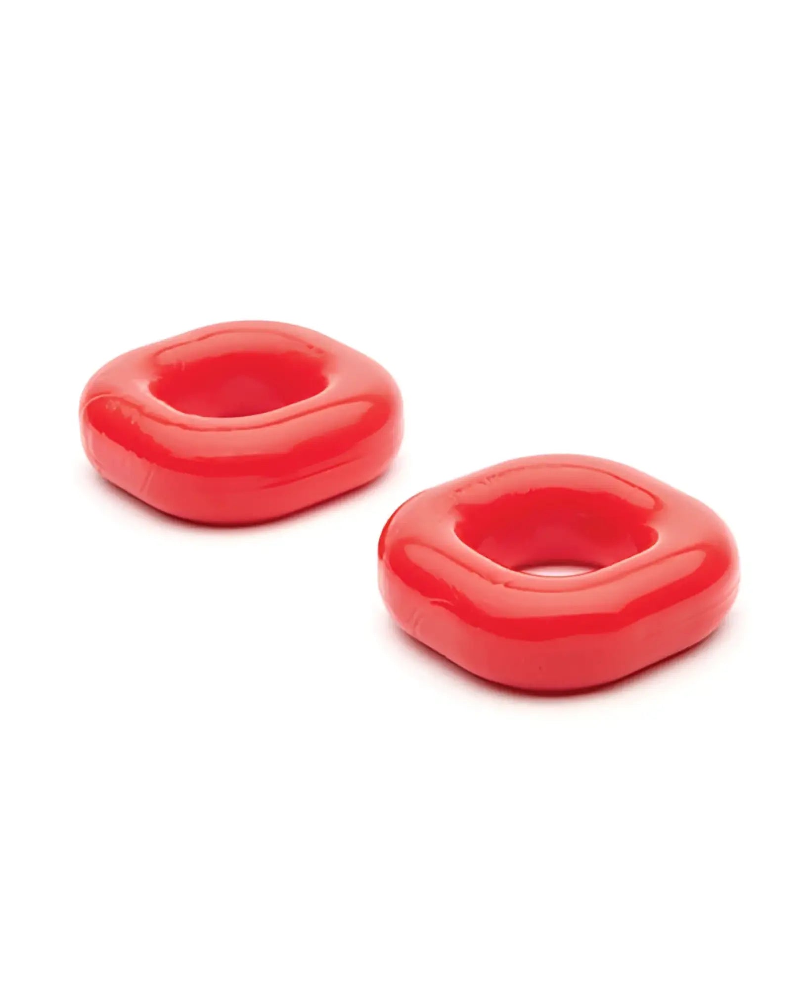 Two vibrant red glossy square silicone rings with rounded edges and central hole from sport fucker boner expansion kit