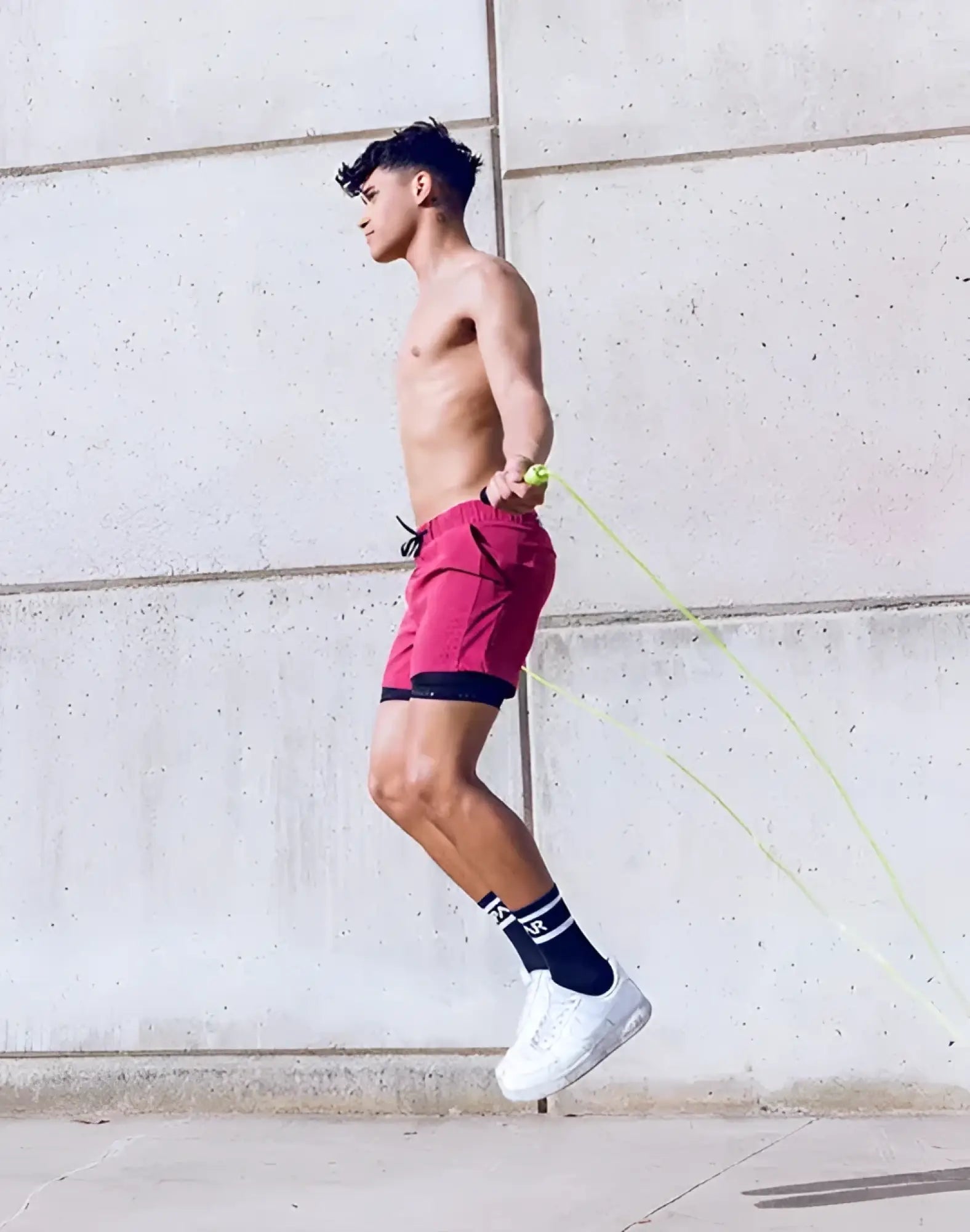 A vibrant red spr max short with black trim and drawstring waistband designed for athletic use