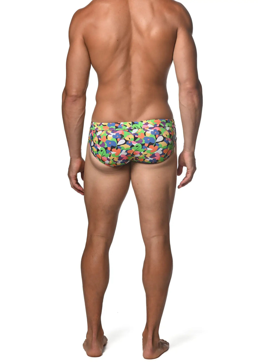 Spring green abstract freestyle swim brief with vibrant multicolored swim trunks and playful abstract shapes in green blue orange and purple