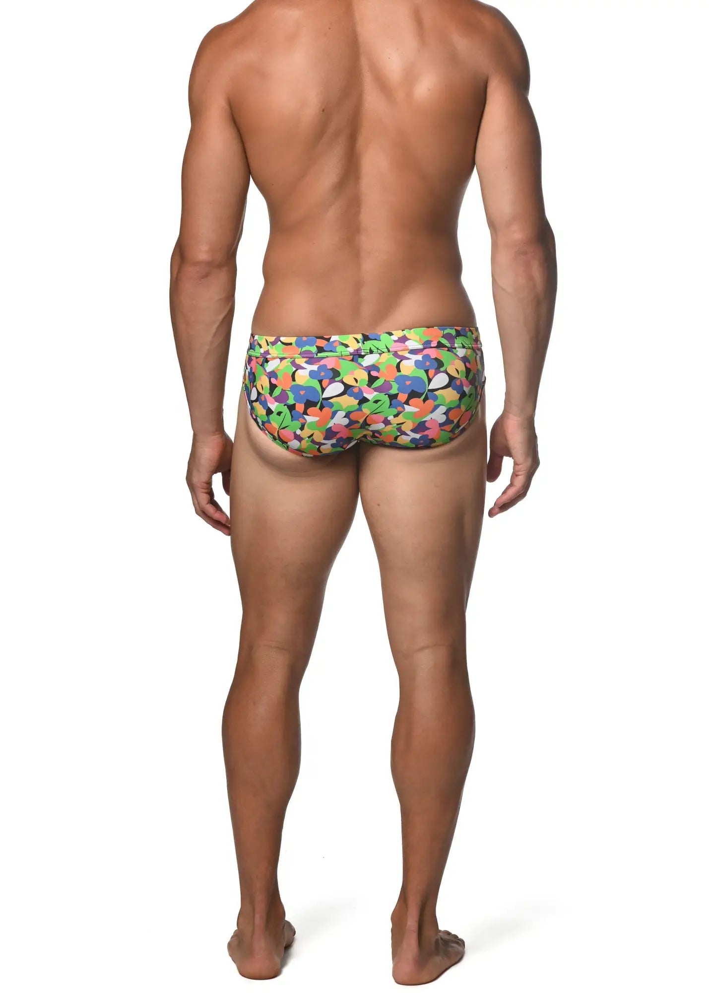 Spring green abstract freestyle swim brief with vibrant multicolored swim trunks and playful abstract shapes in green blue orange and purple