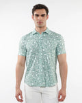 A man wearing a light green and white squares print open knit short-sleeve polo shirt with geometric patterns