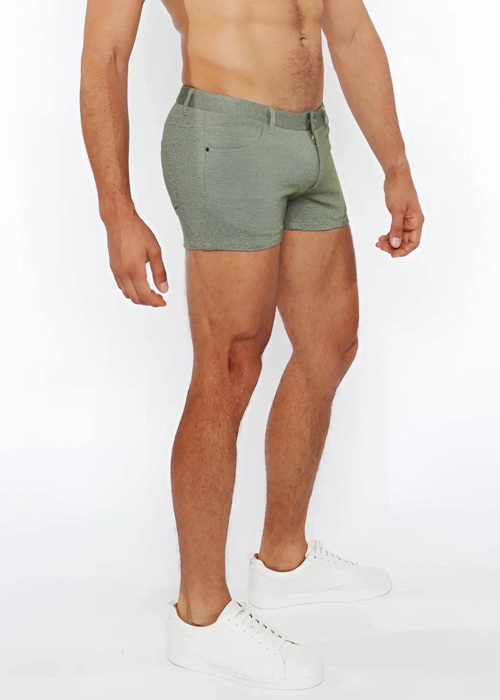 A pair of olive green 3 inch stretch knit two tone shorts with textured fabric belt loop and front pocket