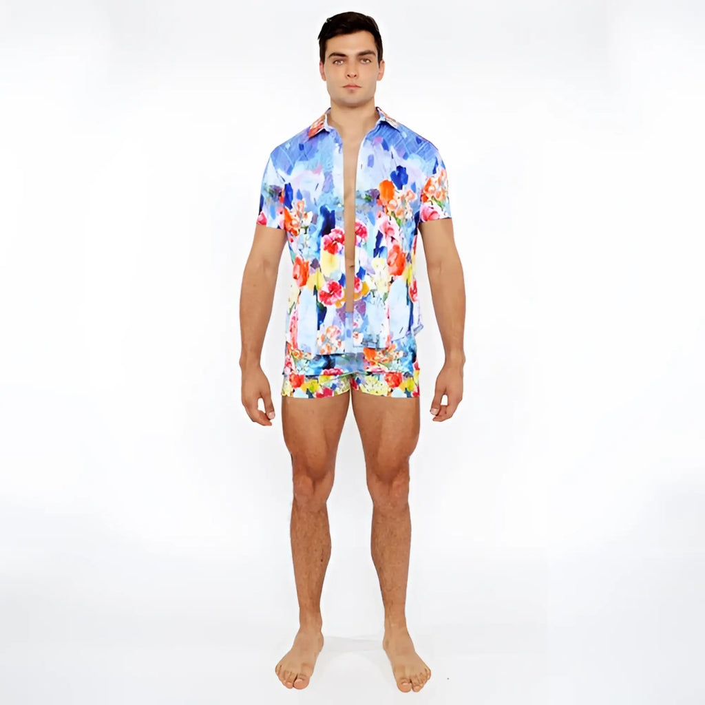 Vibrant blue red and yellow floral abstract printed swim short set featuring a short-sleeved button-up shirt and matching shorts