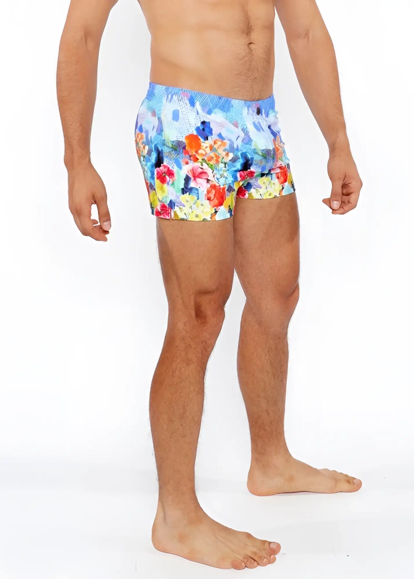 Floral abstract printed swim short featuring vibrant red orange yellow and blue floral pattern perfect for beachwear