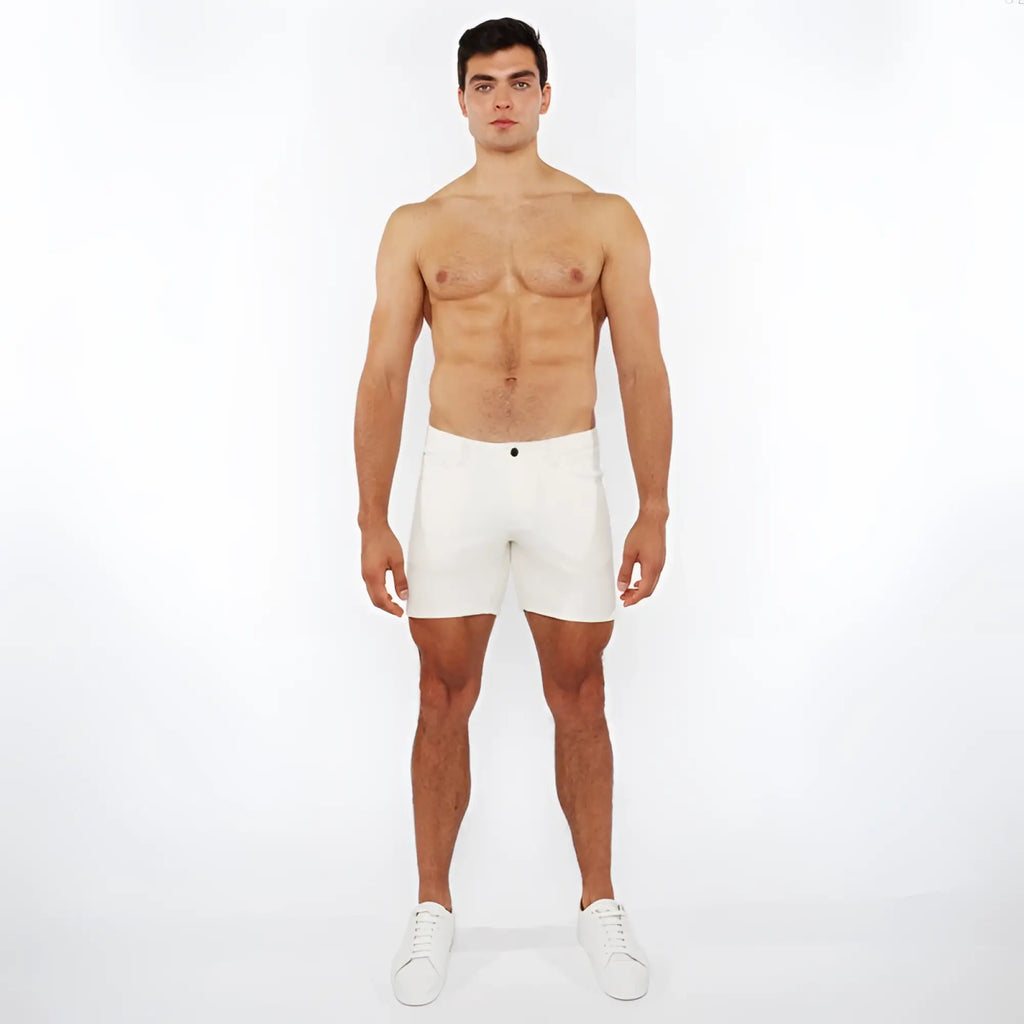White jaquard stretch knit chino shorts with a sleek minimalist design and a single black button at the waistband