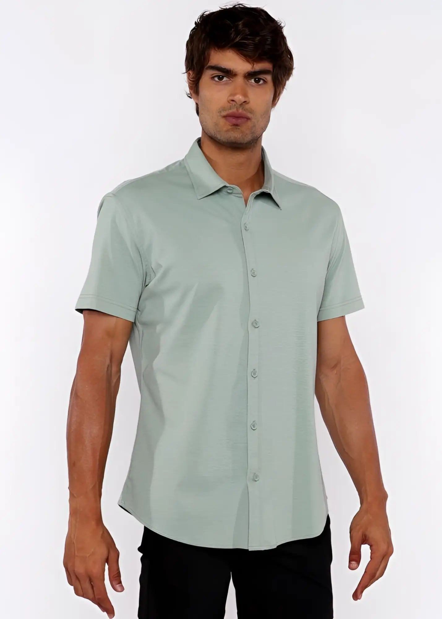 A man wearing a light green stretch knit short-sleeved shirt with classic collar and neatly pressed fabric