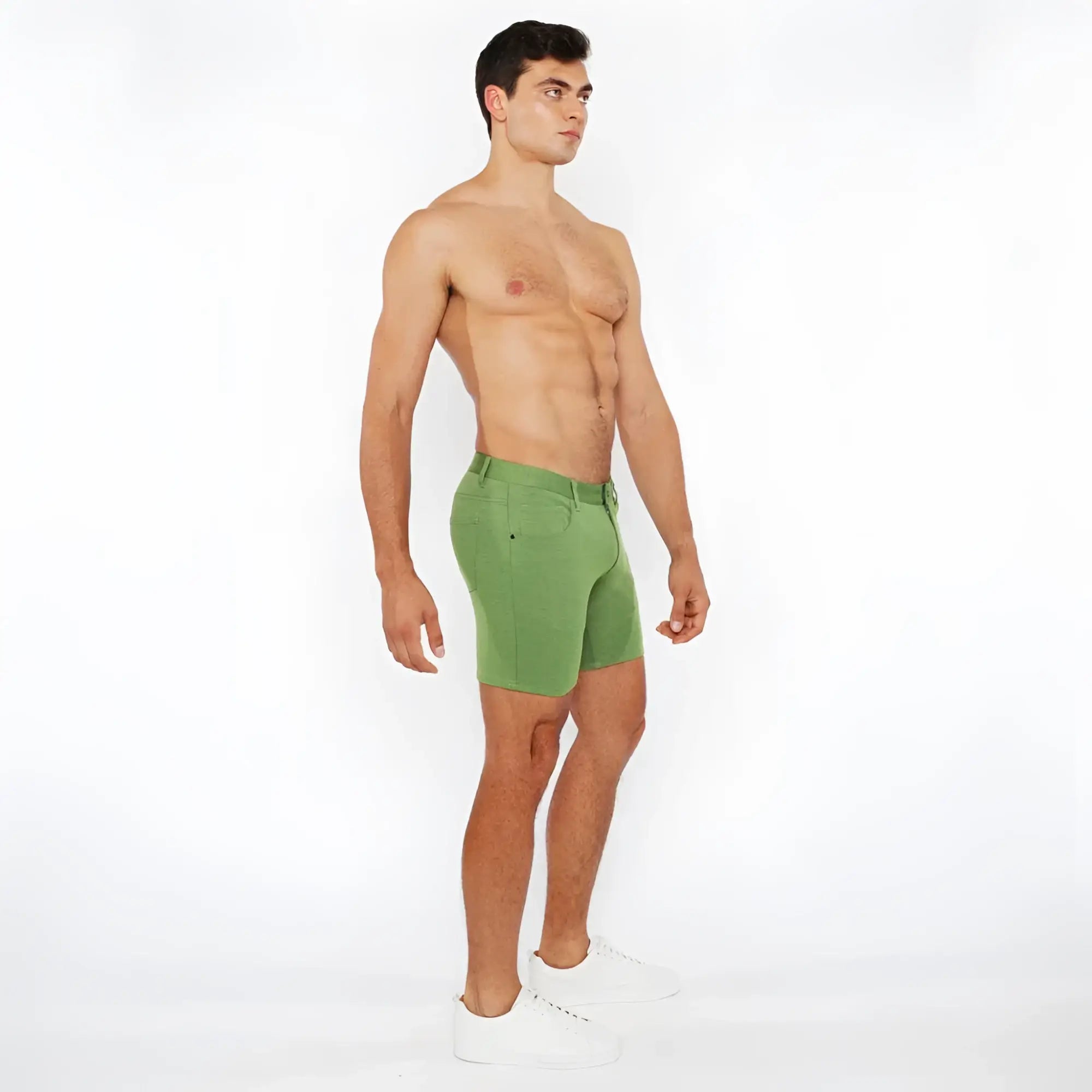 Green stretch knit short with fitted cut and visible stitching made of breathable athletic fabric