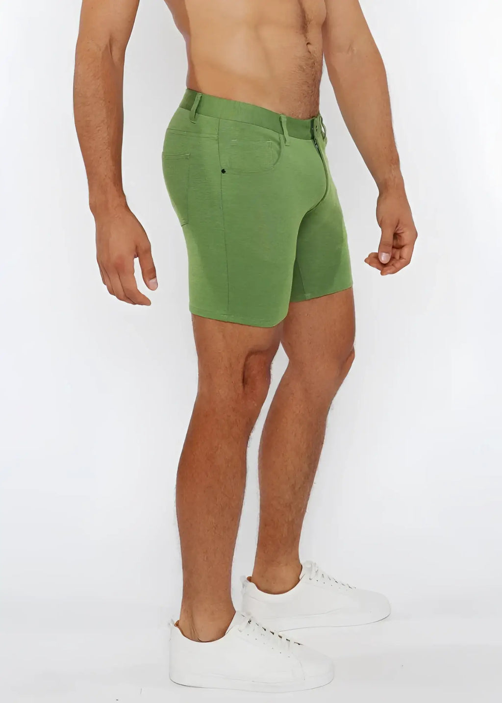 Green stretch knit shorts with classic five-pocket design and belt loop waistband made from denim material