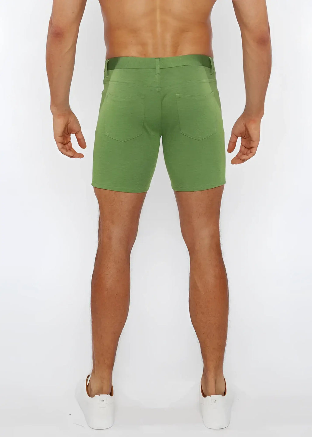 Green stretch knit shorts with a straight-leg cut and rear pockets shown from the back side