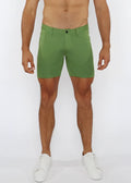 Green stretch knit shorts with subtle textured fabric and classic five-pocket design for comfortable wear