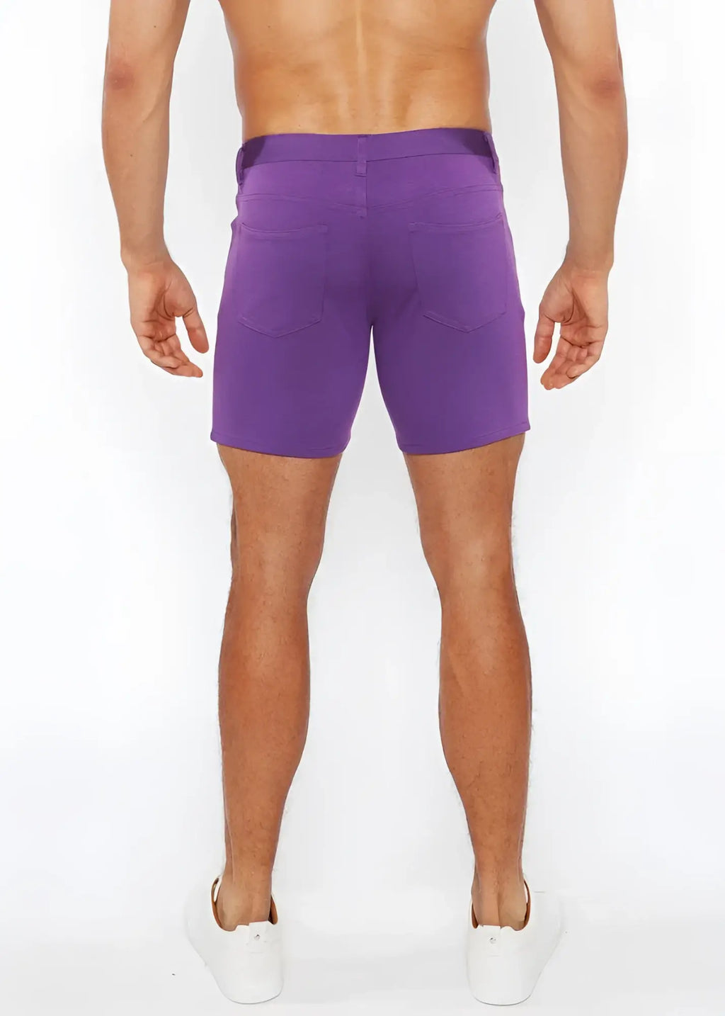 Purple stretch knit shorts with a straight-leg cut and two back pockets shown from the back side