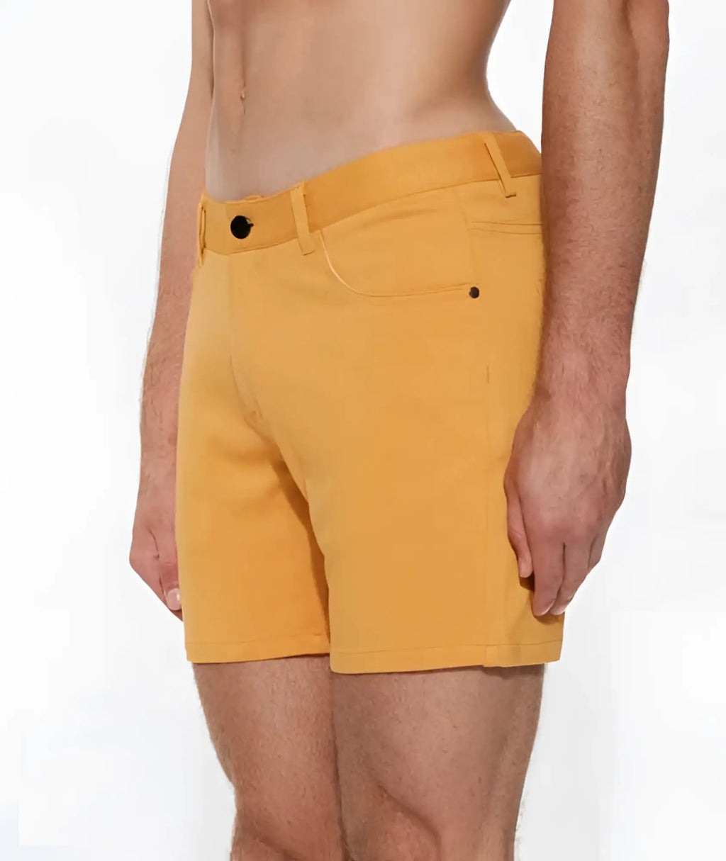 Bright yellow ST33LE stretch knit shorts with sleek modern design and black button closures size 28 apricot peel
