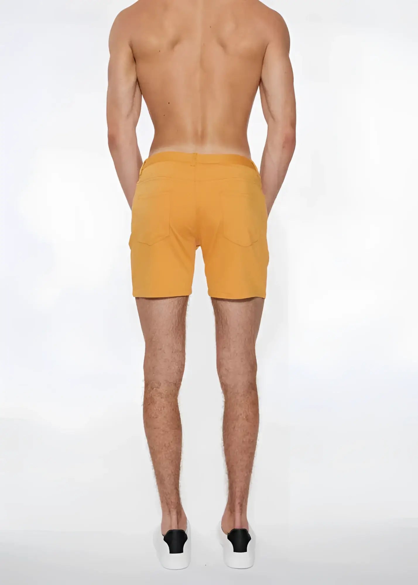 A pair of mustard yellow st33le stretch knit shorts with side pockets in size 29 apricot peel color