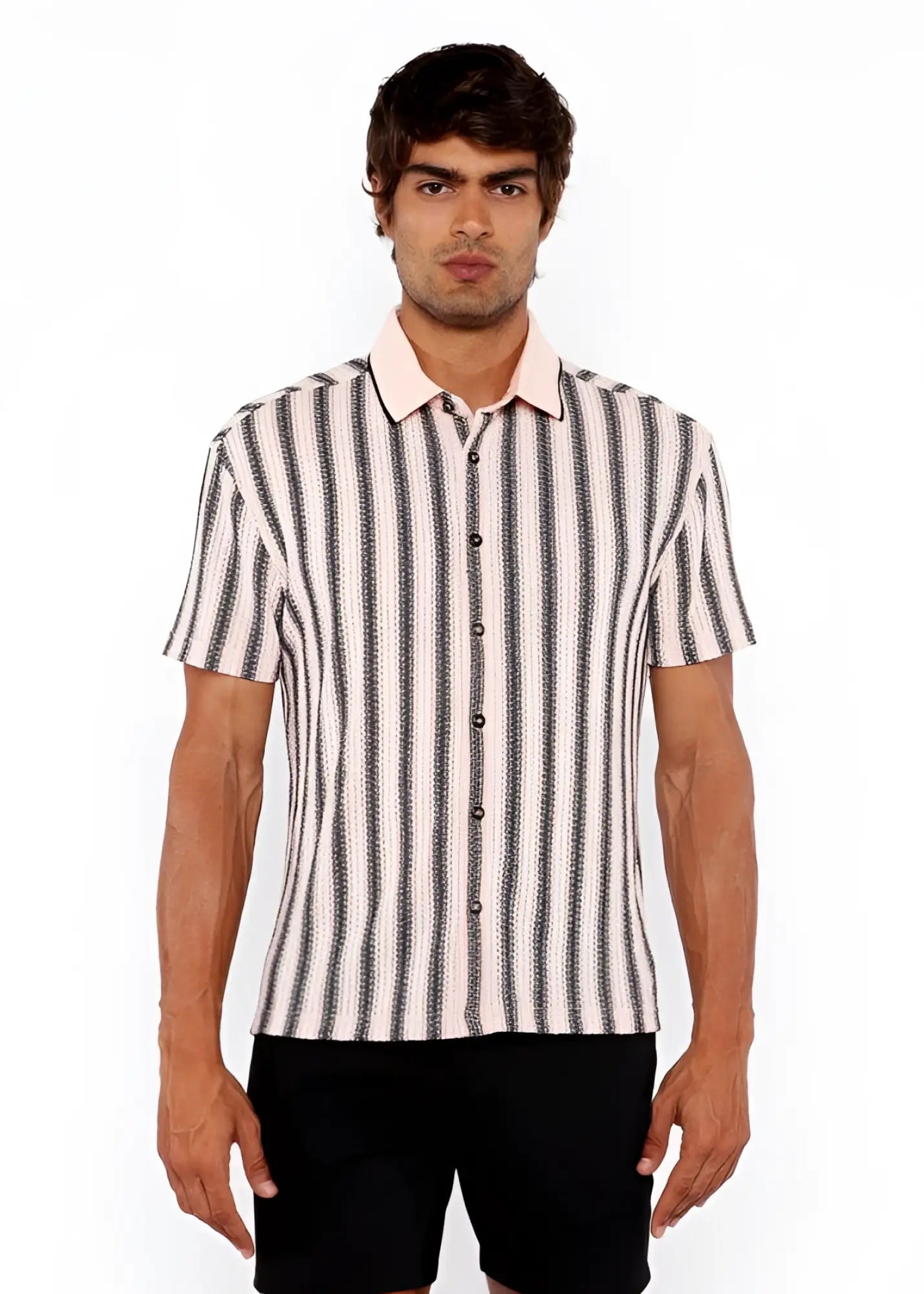 A man wearing a black and off-white vertical stripe open stretch knit shirt with rib collar and short sleeves