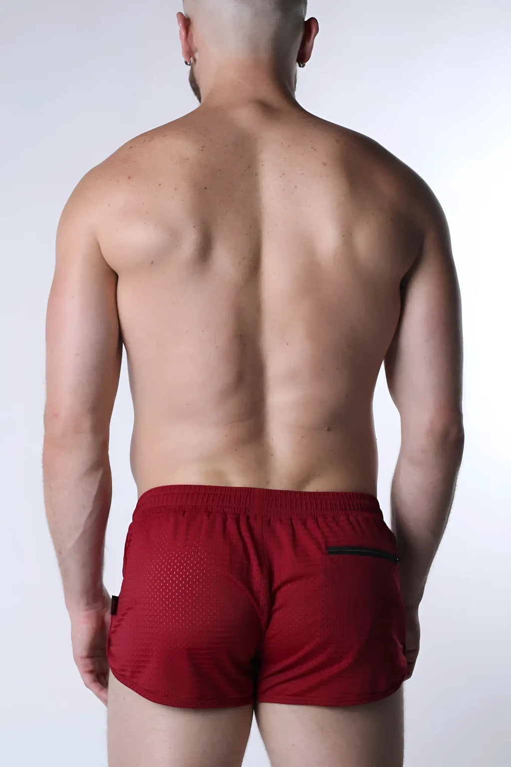 Red starter mesh short with breathable mesh texture and black trim on side pockets for athletic use
